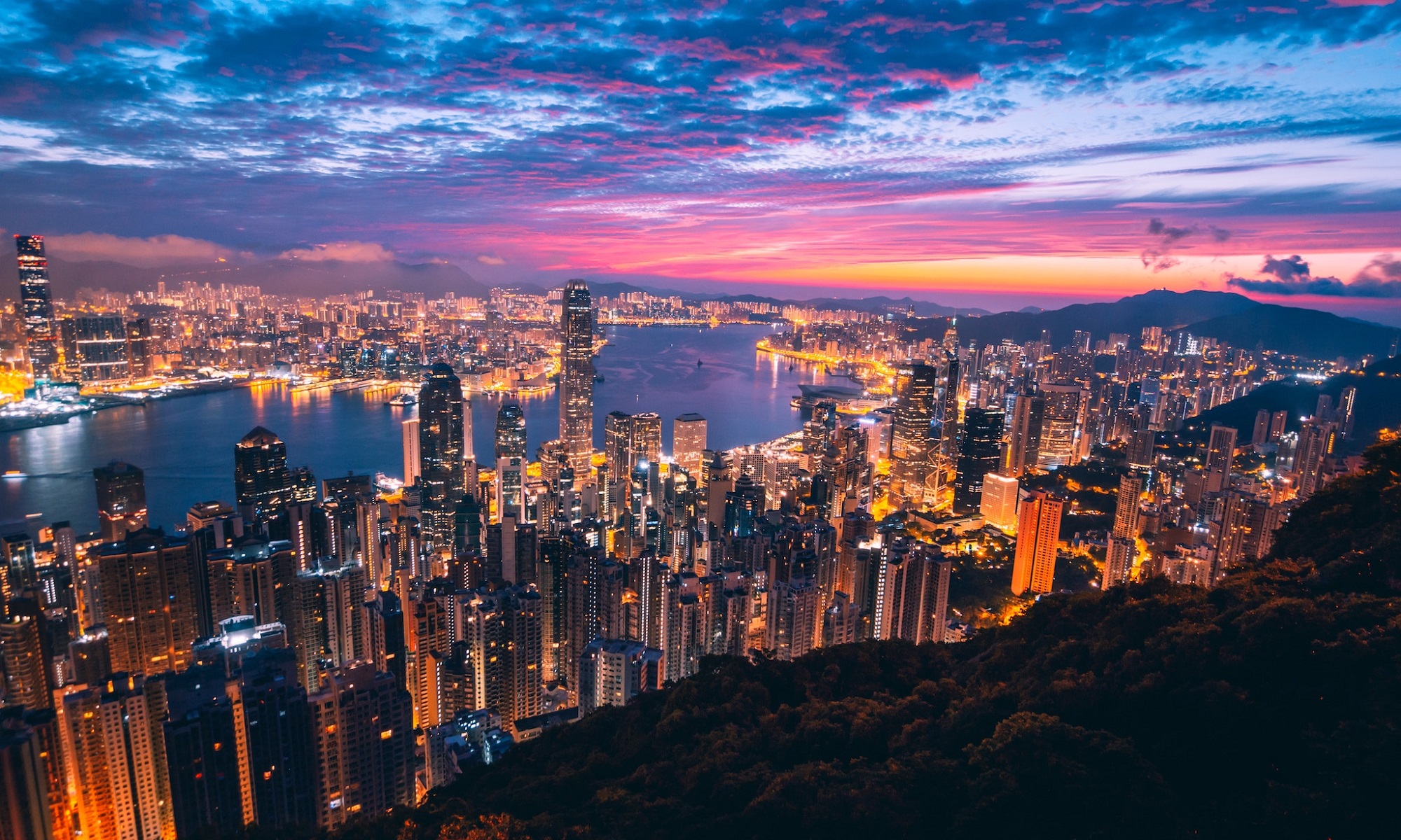 Panorama view of Hong Kong bay from Victoria Peak summit at sunset.