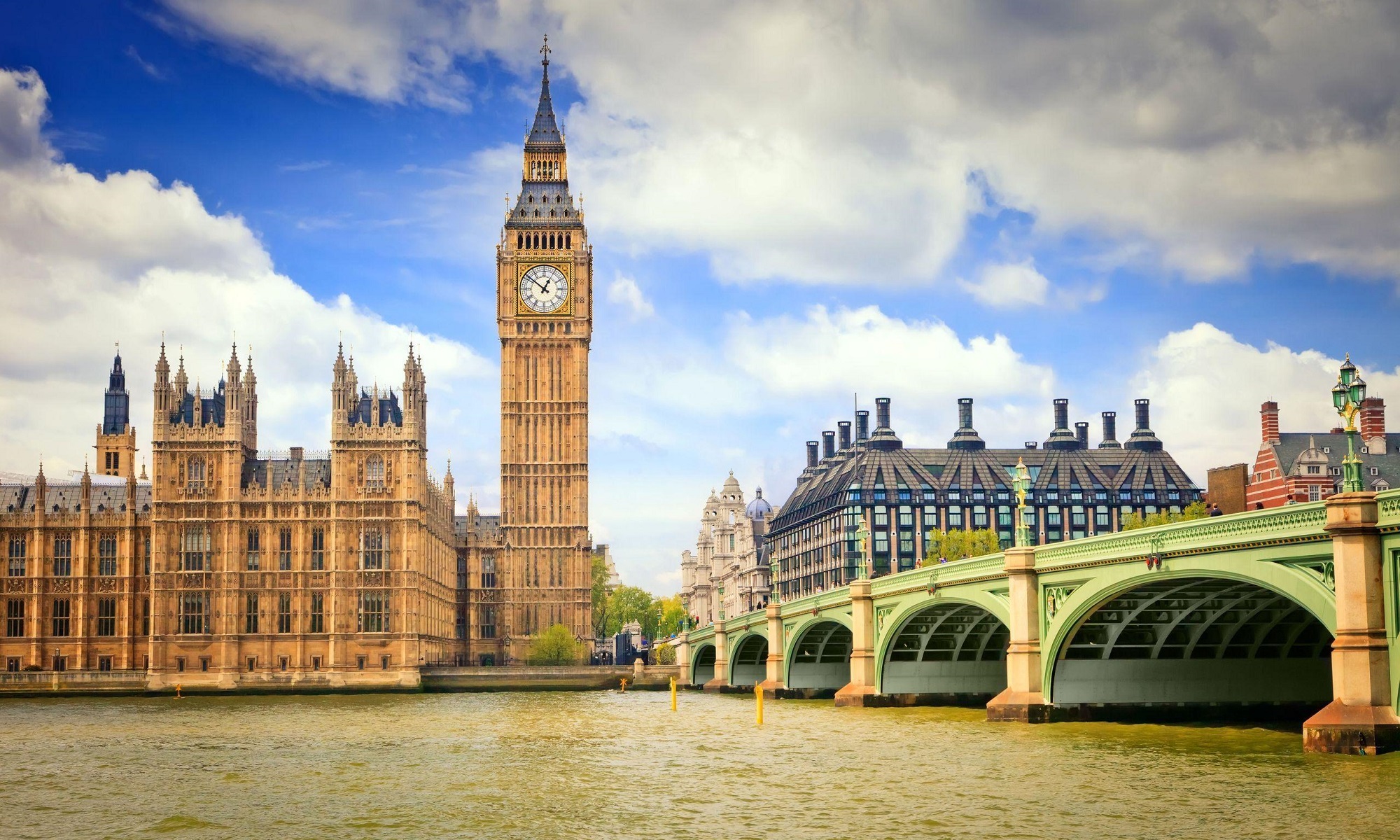 Big Ben and Westminster bridge across Thames river.