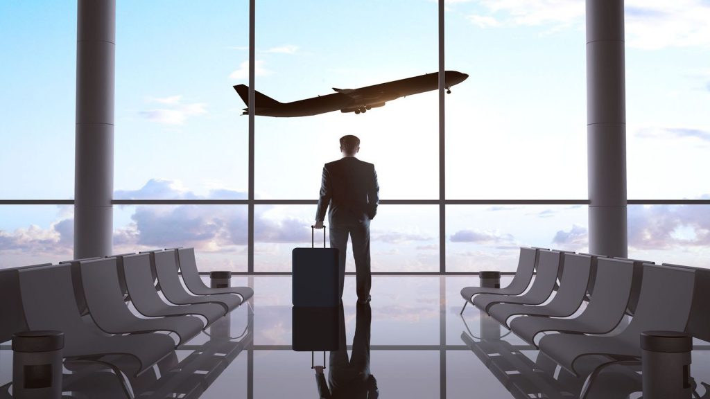 Business man standing in the airport, waiting for his flight.