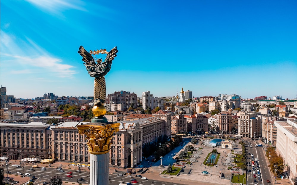 a view of a city with a statue in the middle