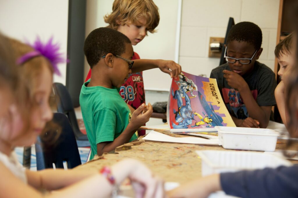 children with a book in class